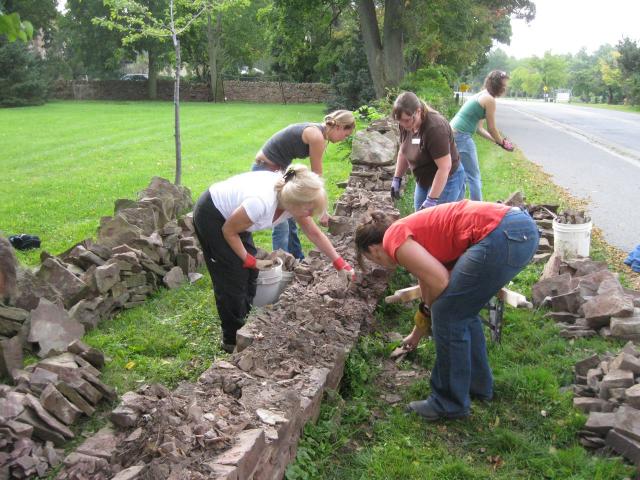 Students at the Willowbank Workshop taking apart the damaged wall.